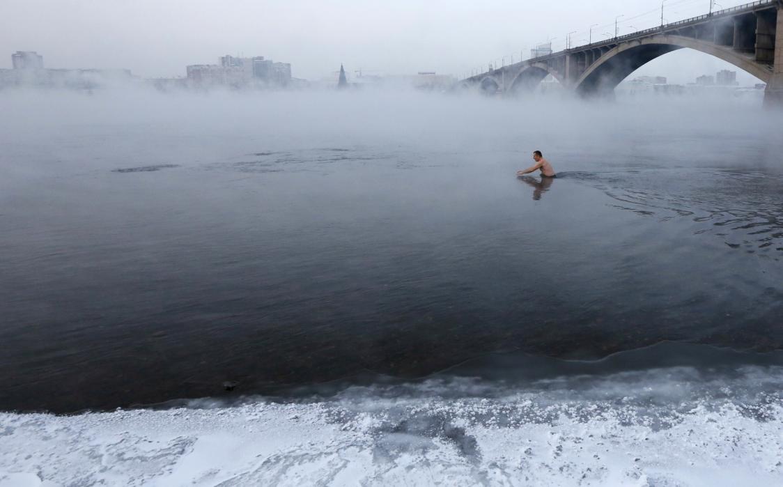 53, a fan of winter swimming, dips to the yenisei river at air